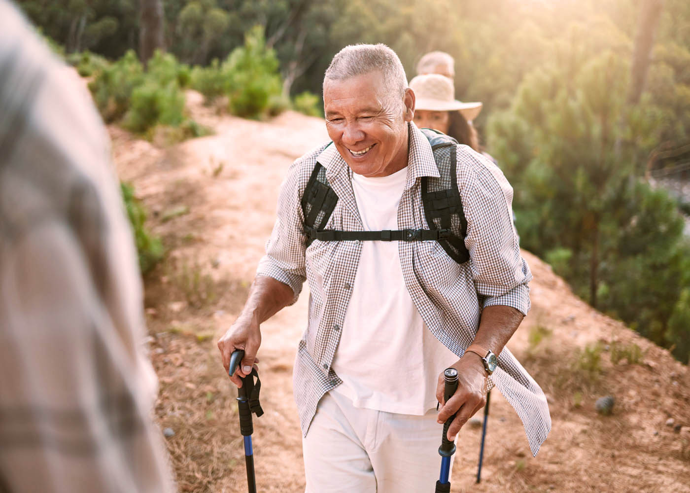 A older man hiking and enjoying the positive side effects of red light therapy weight loss.