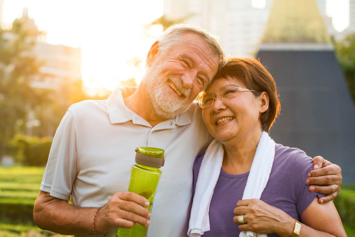 Two older people hugging and enjoying the sunlight - learn about photobiomodulation benefits.